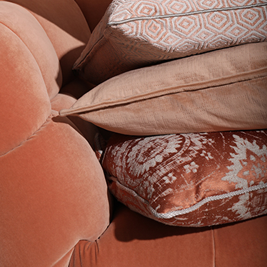 When the Eclectic, Geometric and Modern pillows meet the refined elegance of the ESSEX Rare Armchair in a soft orange color scheme, your home decor will be ready to bring Summer feelings indoors.